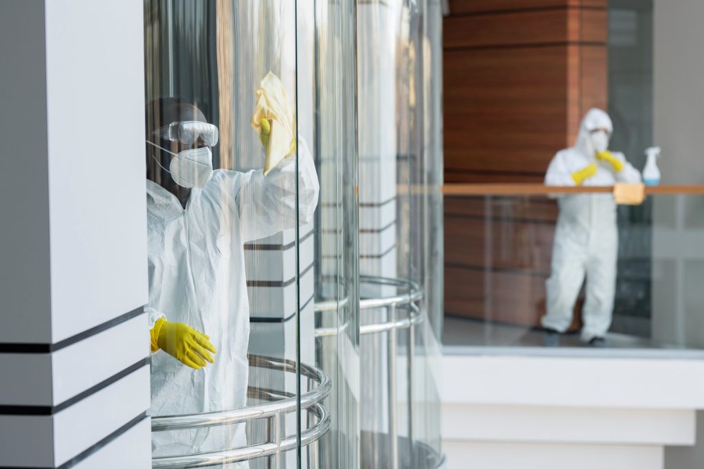 Professional cleaners geared up and cleaning a facility