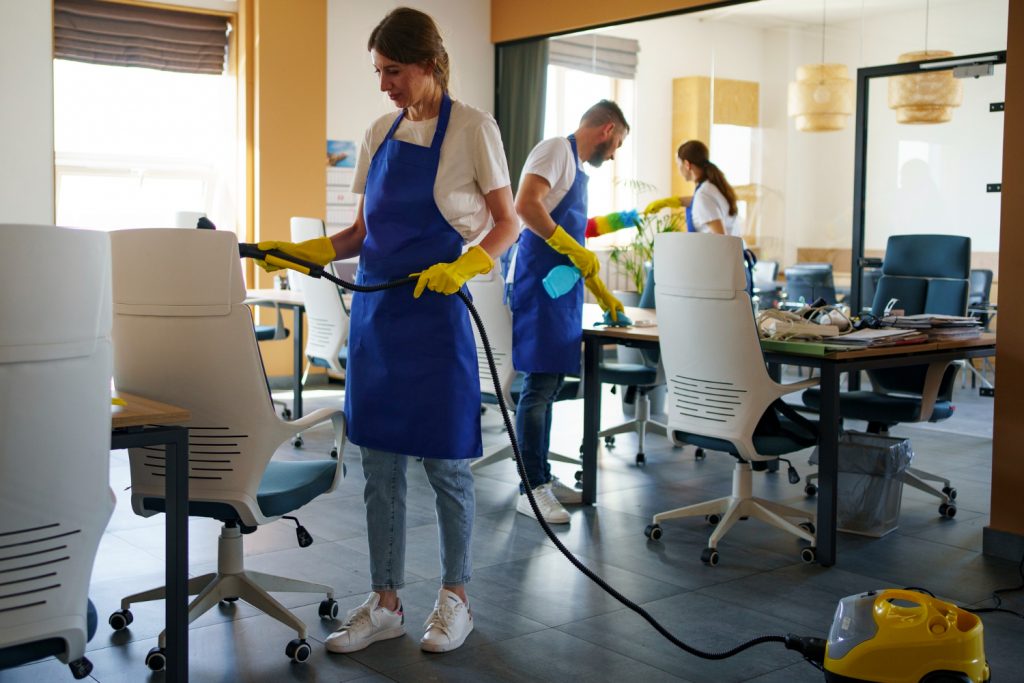 A group of professional cleaners cleaning a space.